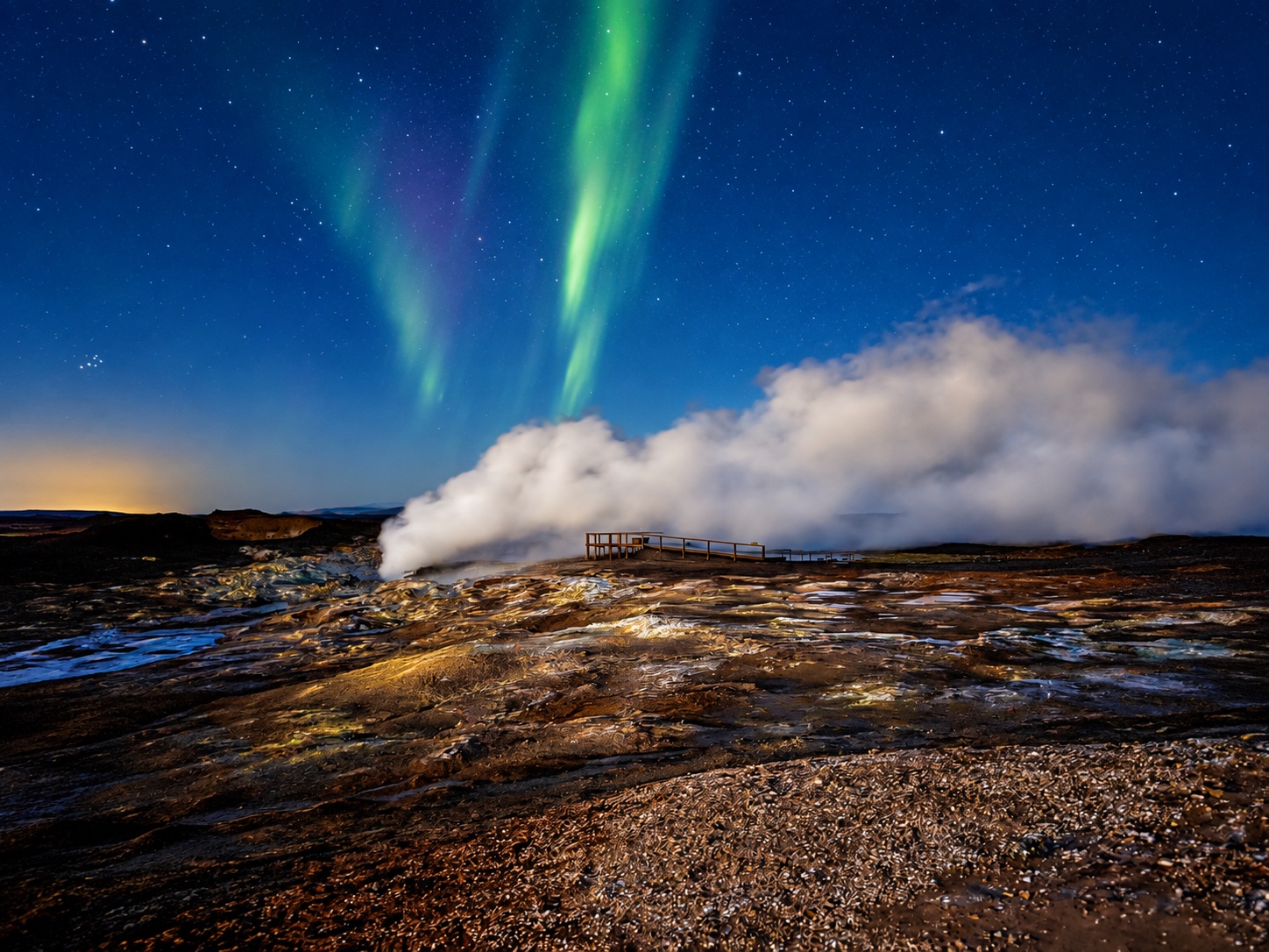 Northern lights above the steaming ground at Gunnuhver