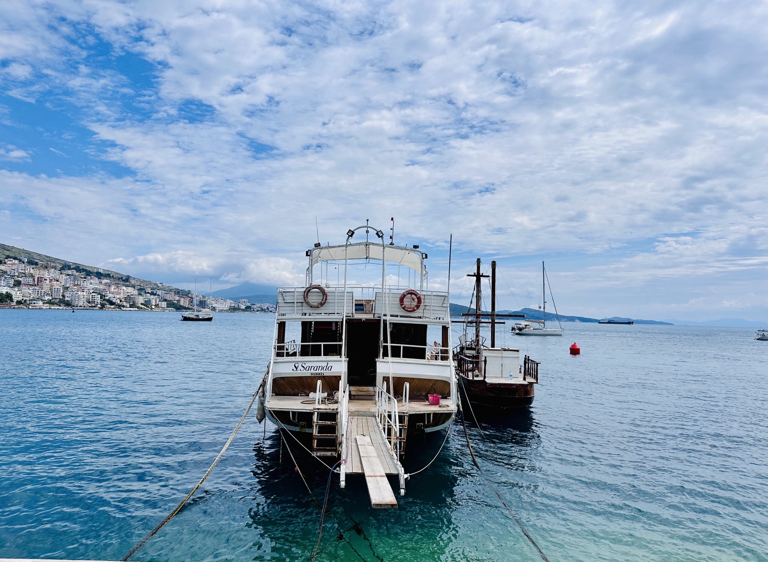 Sarandë’s waterfront, with the city rising around the bay.